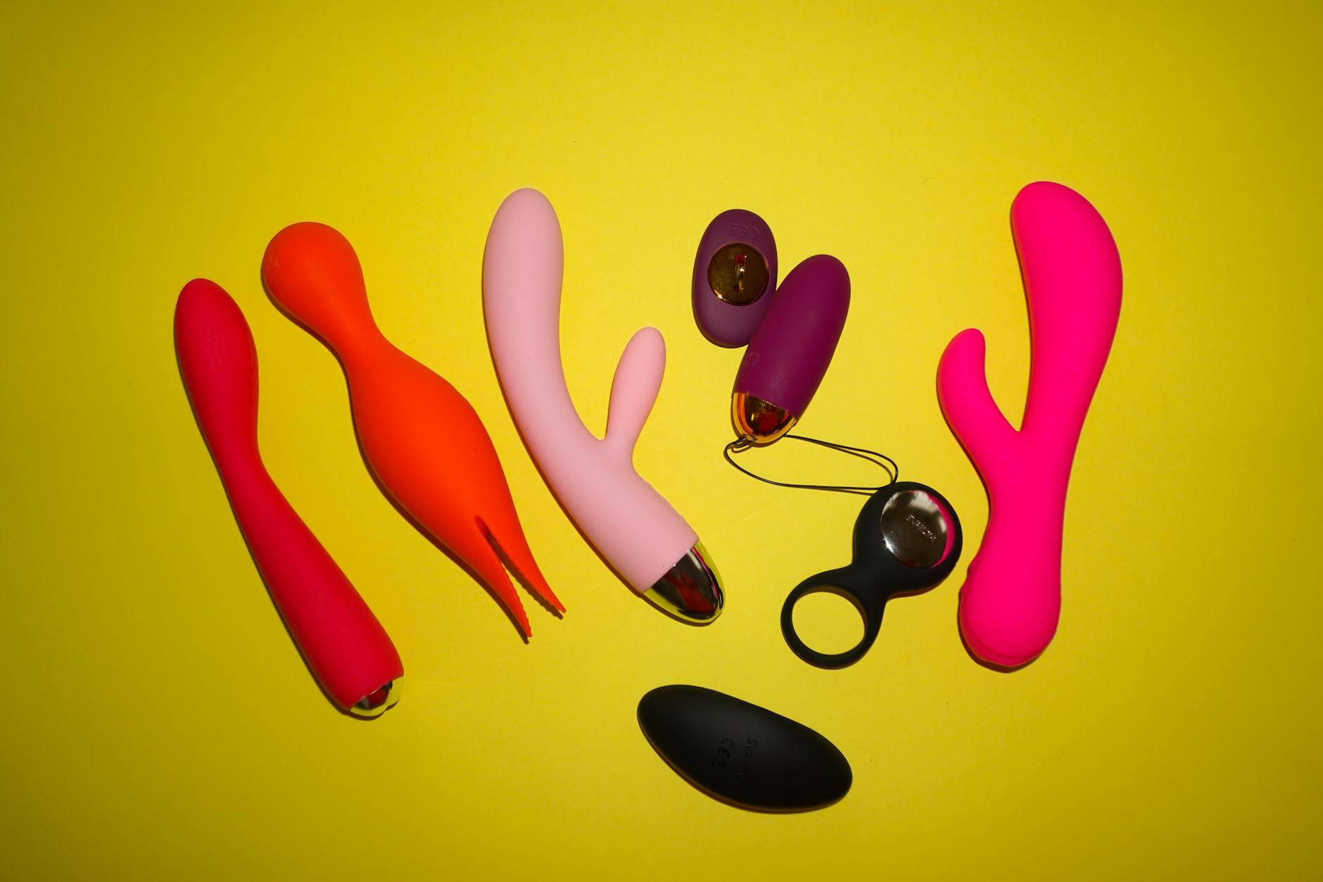 A stylish teal vibrator on smooth white silk fabric for couples exploring intimacy together